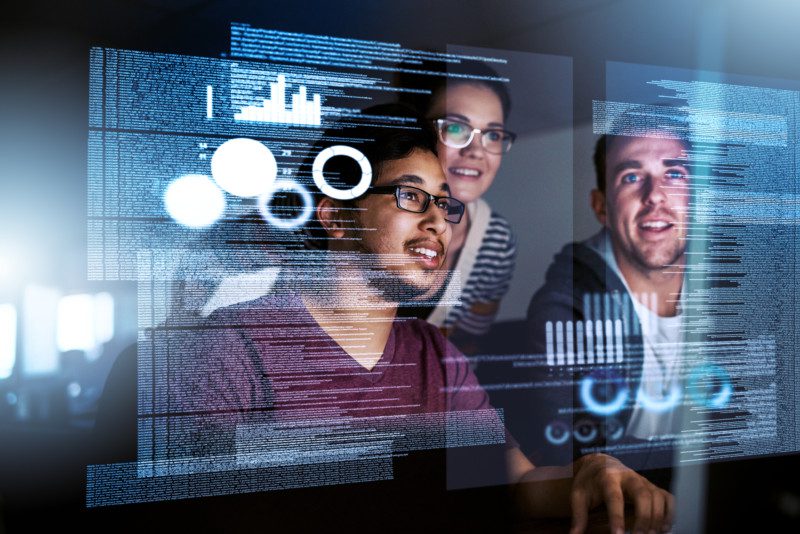 Two Men and one women looking at data